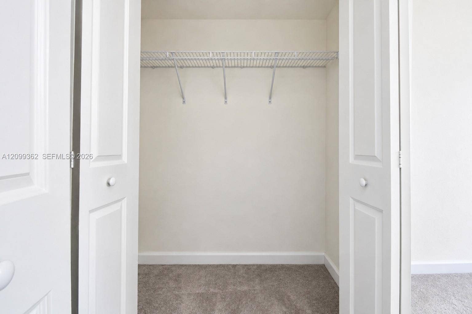 16230 SW 290th Terrace, Homestead, FL 33033 Closet featuring white bi-fold doors and overhead wire shelving