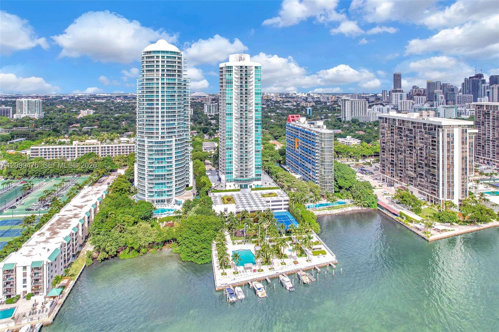 High-rise residential towers featuring private boat slips, swimming pools, tennis courts, and expansive waterfront positioning