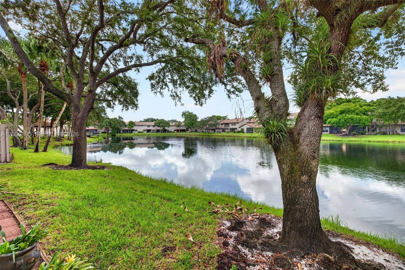 9012 Vineyard Lake Drive, Plantation, FL 33324 Serene lake views create a peaceful backdrop from the home's outdoor living space.