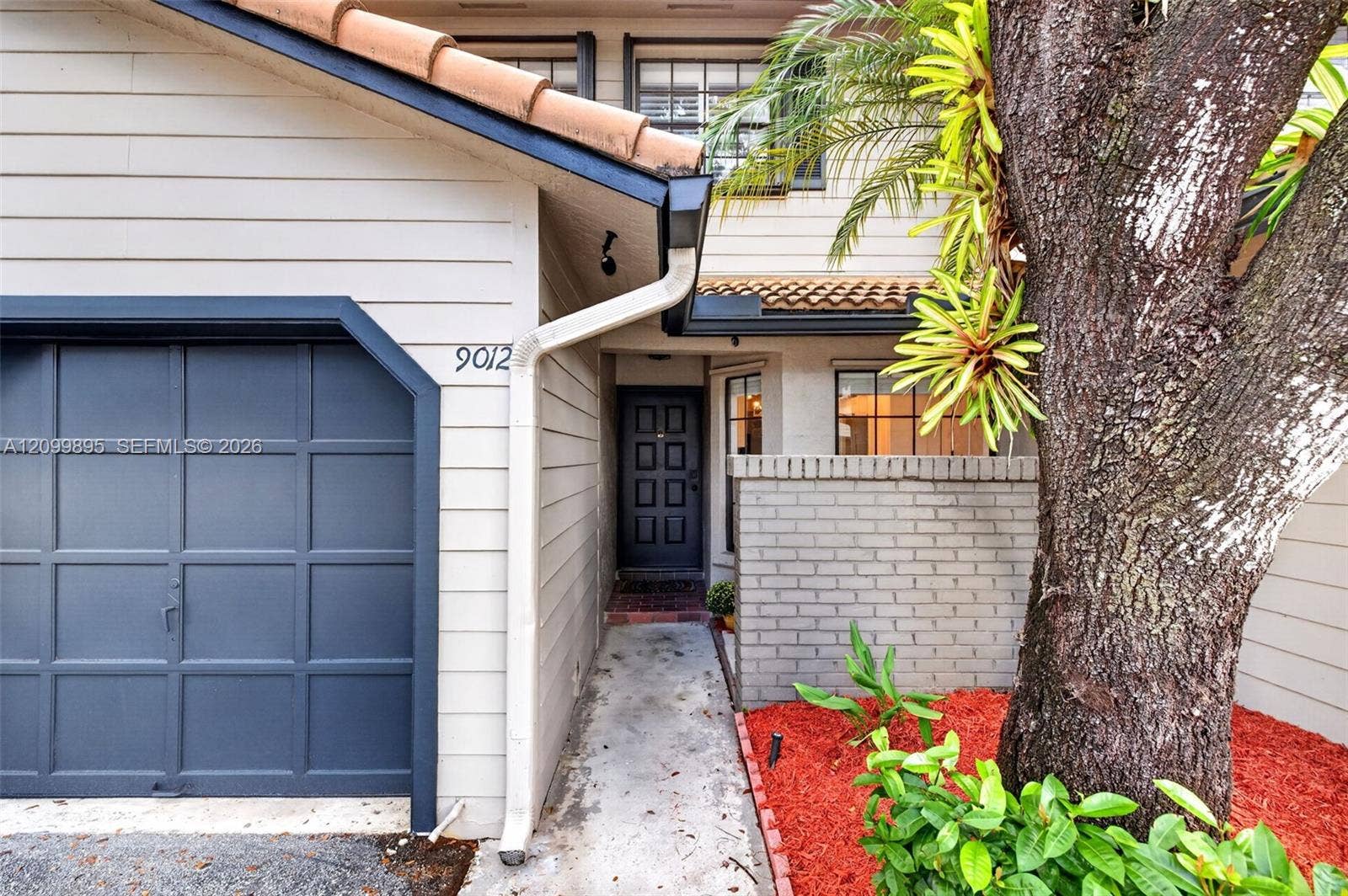 9012 Vineyard Lake Drive, Plantation, FL 33324 Attached one-car garage provides convenient parking and additional storage space.