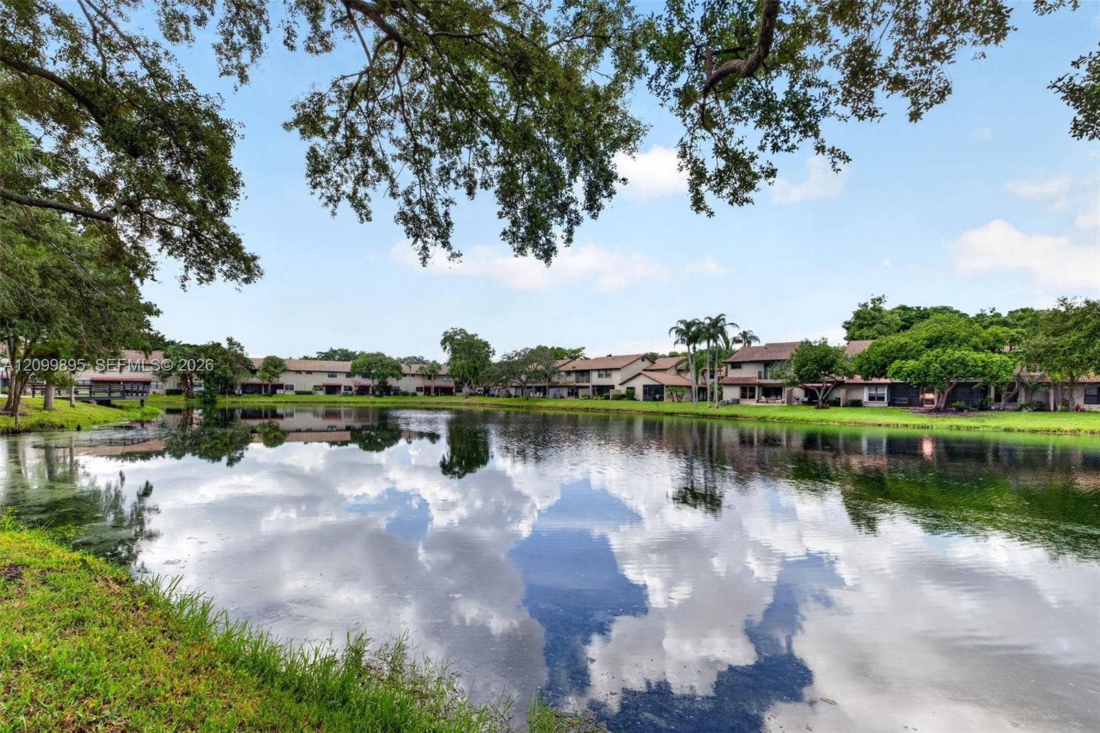 9012 Vineyard Lake Drive, Plantation, FL 33324 Serene lake views create a peaceful backdrop from the home's outdoor living space.