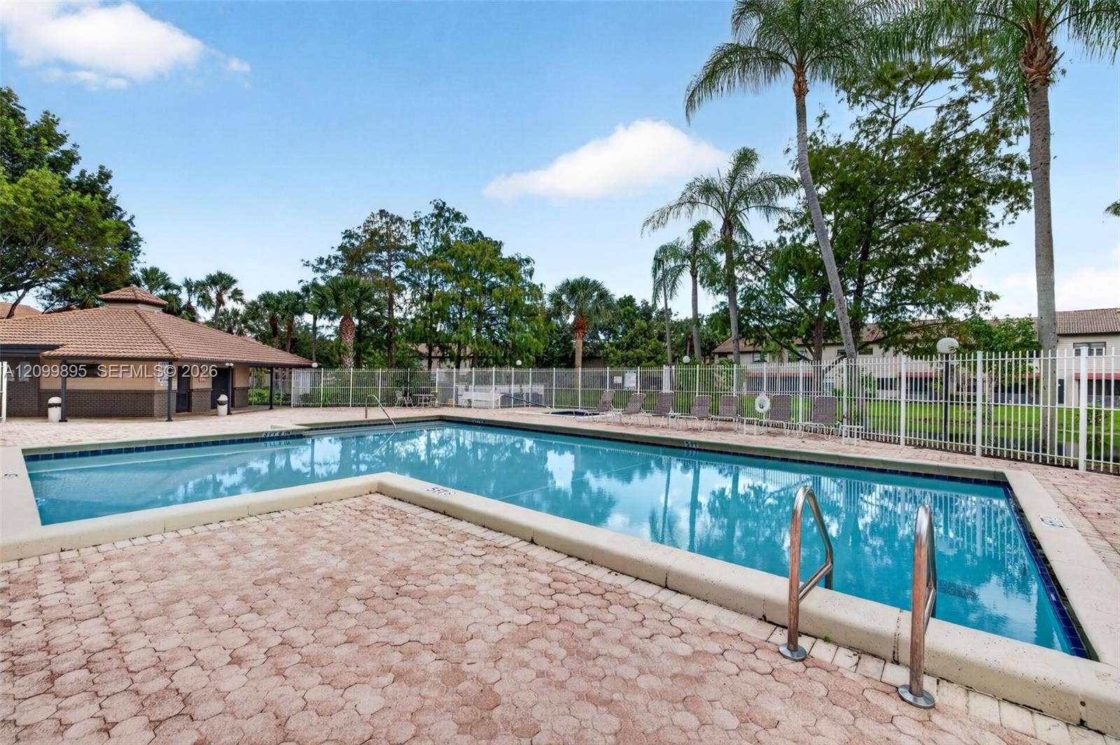 9012 Vineyard Lake Drive, Plantation, FL 33324 Serene lake views create a peaceful backdrop from the home's outdoor living space.
