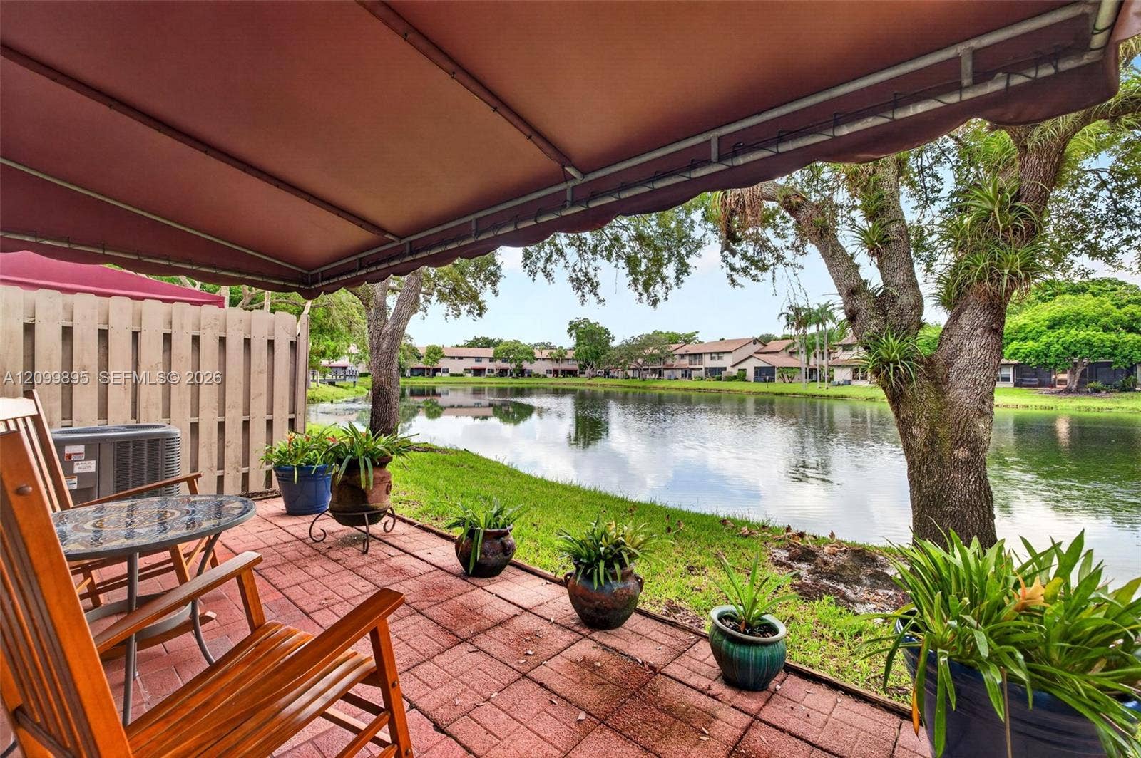 9012 Vineyard Lake Drive, Plantation, FL 33324 Private patio overlooking peaceful lake views and providing an inviting outdoor retreat.