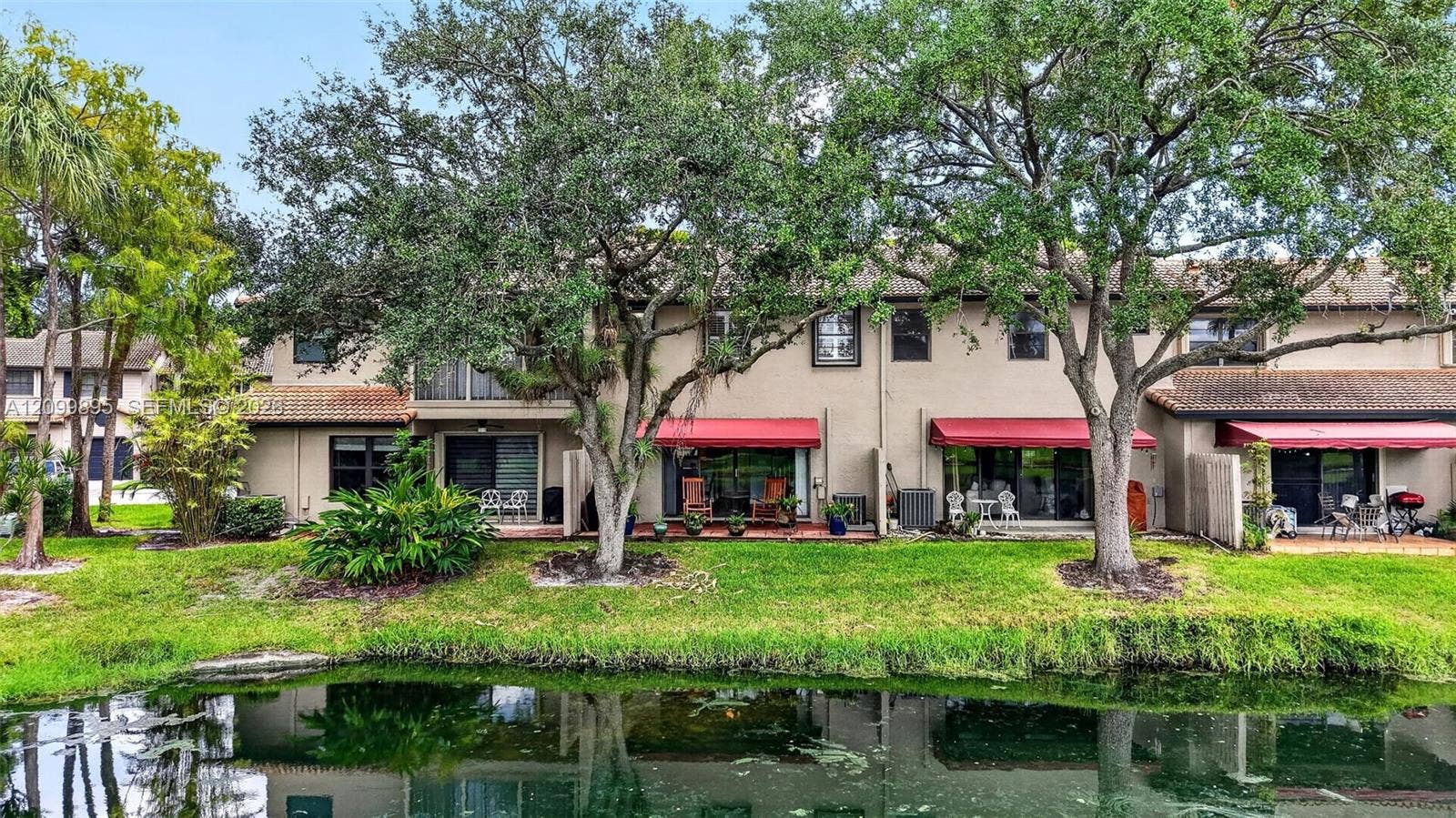 9012 Vineyard Lake Drive, Plantation, FL 33324 Private patio overlooking peaceful lake views and providing an inviting outdoor retreat.