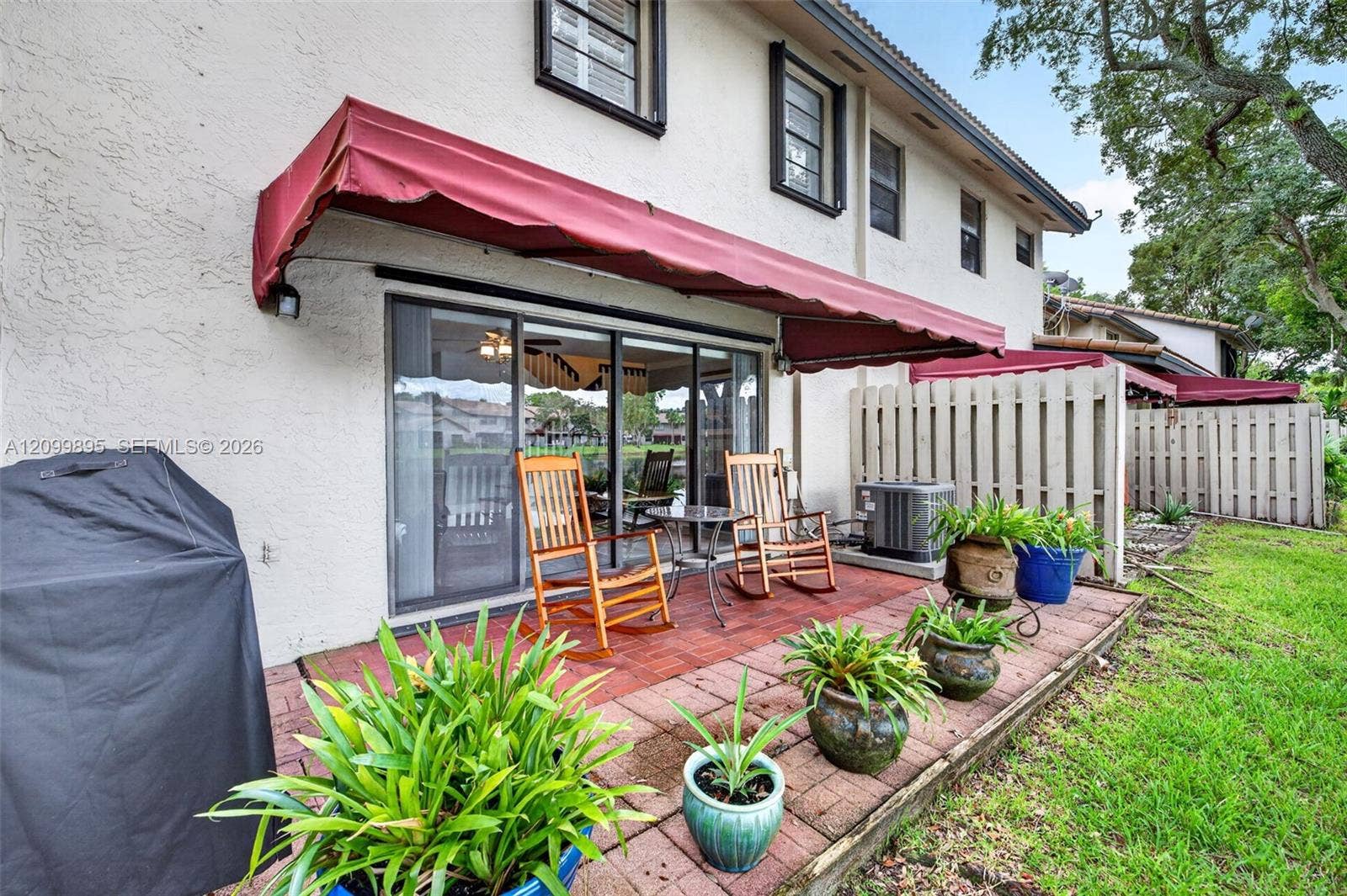 9012 Vineyard Lake Drive, Plantation, FL 33324 Private patio overlooking peaceful lake views and providing an inviting outdoor retreat.