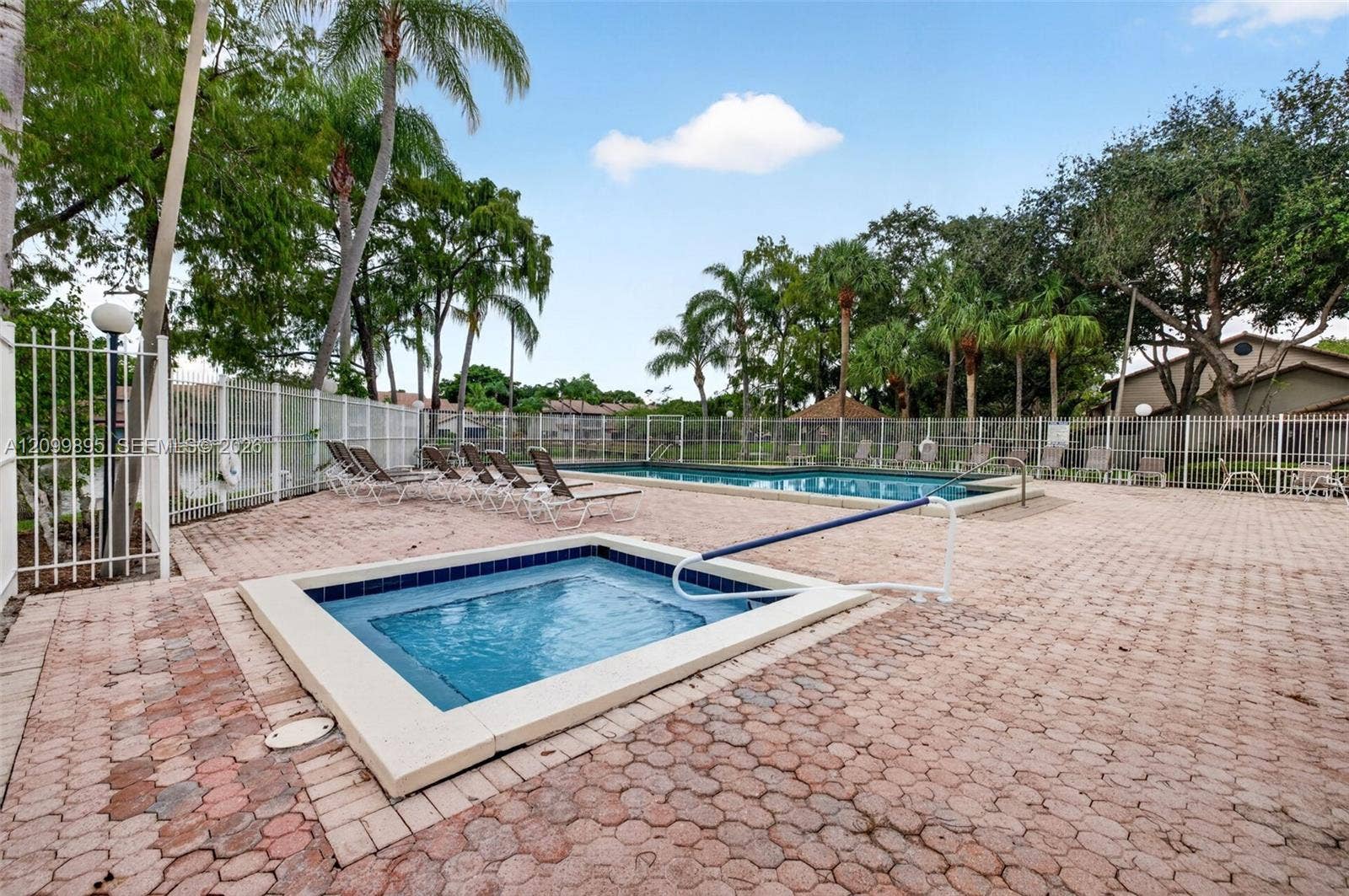 9012 Vineyard Lake Drive, Plantation, FL 33324 Community pool offers a relaxing setting for swimming and outdoor recreation.