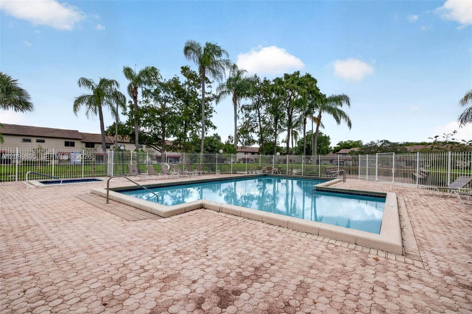 9012 Vineyard Lake Drive, Plantation, FL 33324 Community pool offers a relaxing setting for swimming and outdoor recreation.
