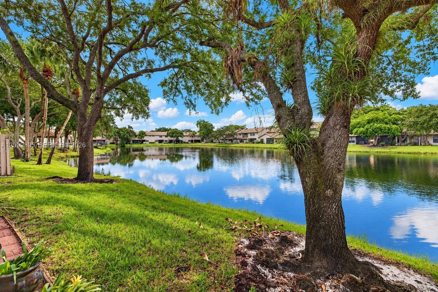9012 Vineyard Lake Drive, Plantation, FL 33324 Private patio overlooking peaceful lake views and providing an inviting outdoor retreat.