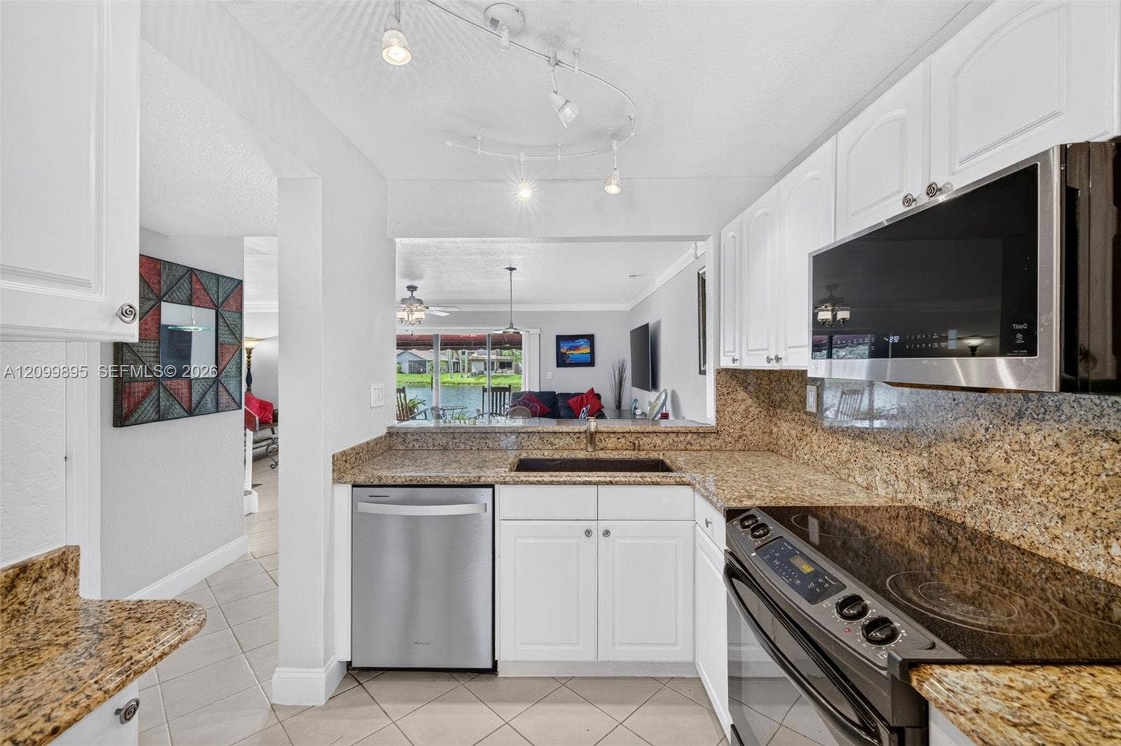 9012 Vineyard Lake Drive, Plantation, FL 33324 Private patio overlooking peaceful lake views and providing an inviting outdoor retreat.