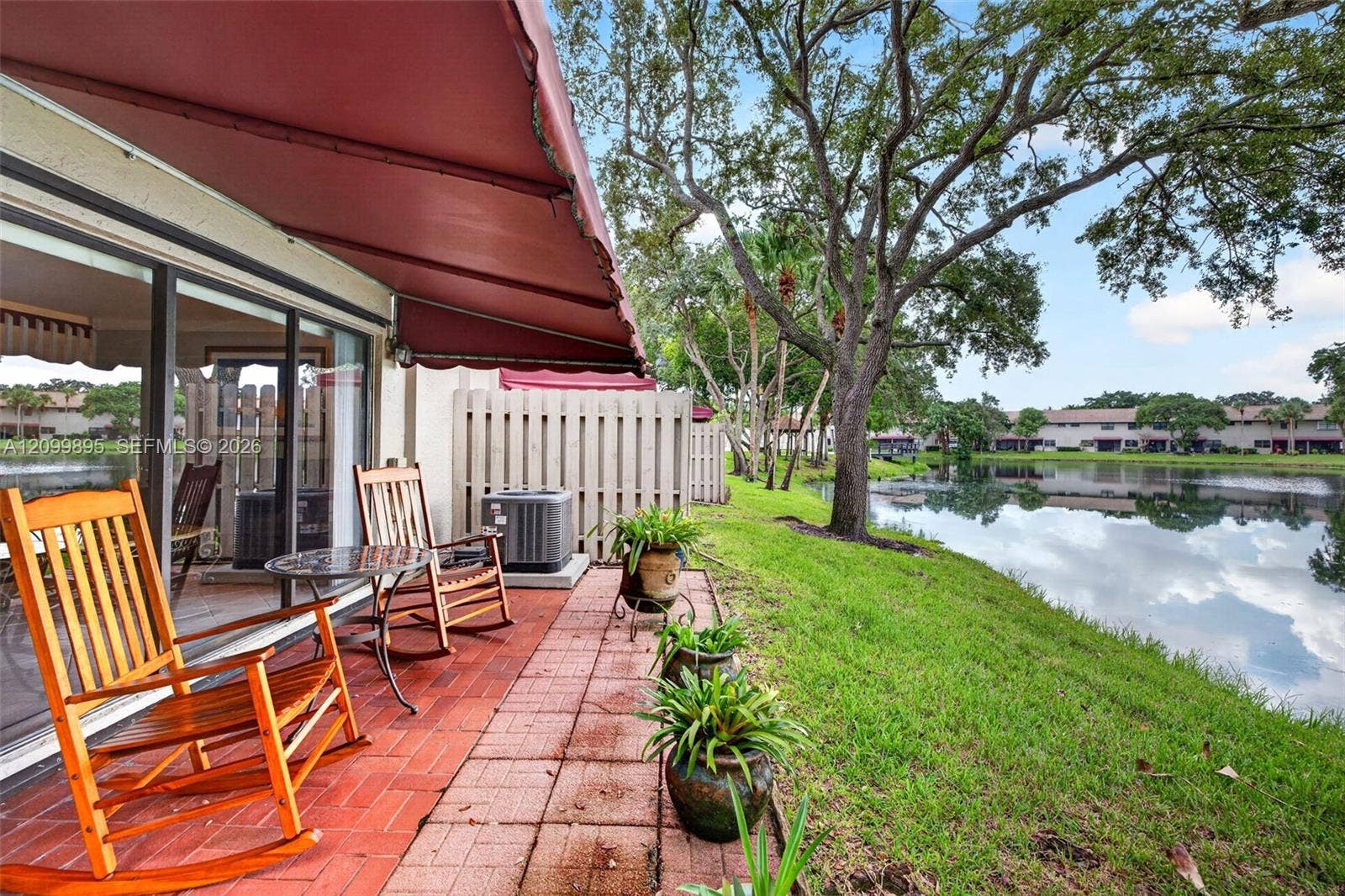 9012 Vineyard Lake Drive, Plantation, FL 33324 Private patio overlooking peaceful lake views and providing an inviting outdoor retreat.