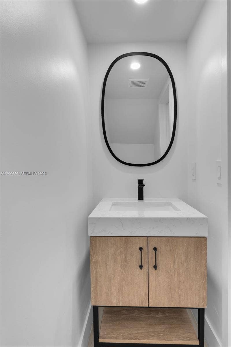 5750 Turin Street, #206, Coral Gables, FL 33146 The "Half-Bath is by the Family-room and has a new vanity & mirror & LED lite!.