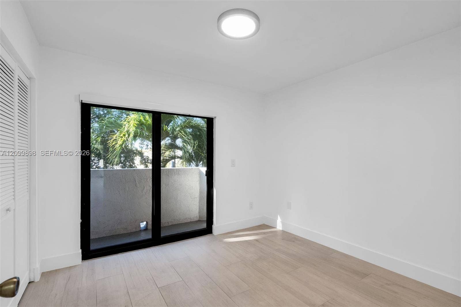 5750 Turin Street, #206, Coral Gables, FL 33146 This is the view looking to the North and the second bedroom has sliding glass doors that open to a small balcony! The second floor landing and both Bedrooms and have the same tile floors. Notice the nice Palm trees that are just off the North facing balcony.
