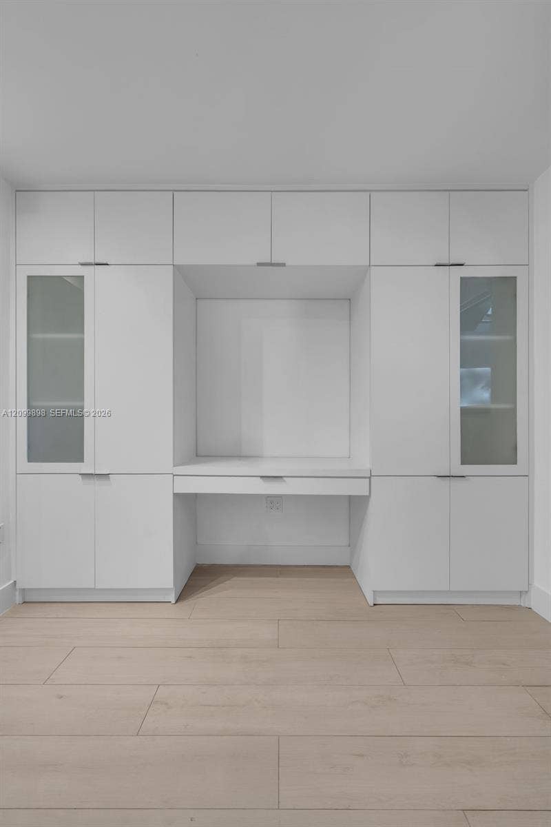 5750 Turin Street, #206, Coral Gables, FL 33146 Look how nice the glass doors look on either side of the built-in computer desk/entertainment center and how much hidden storage one has in this built-in cabinet!