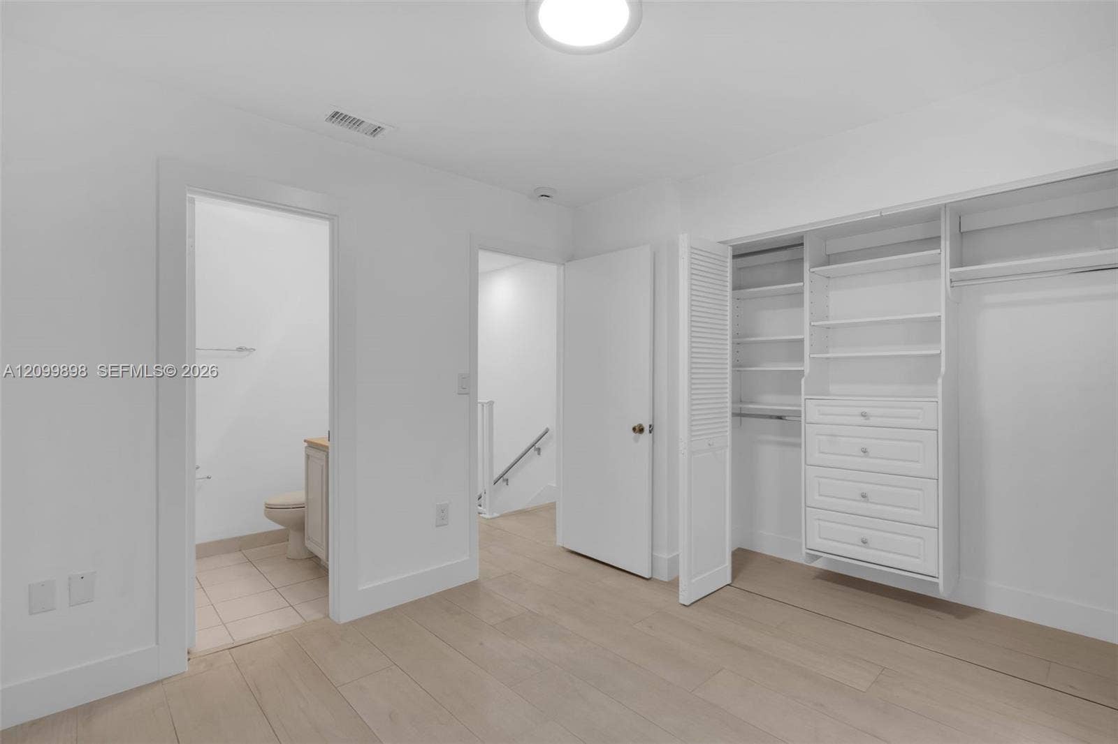 5750 Turin Street, #206, Coral Gables, FL 33146 The second Bedroom faces the North and and notice the built-in closet organizers & in the next picture you will see that their is a small balcony facing North. The left door is the en-suite bathroom with a tub.