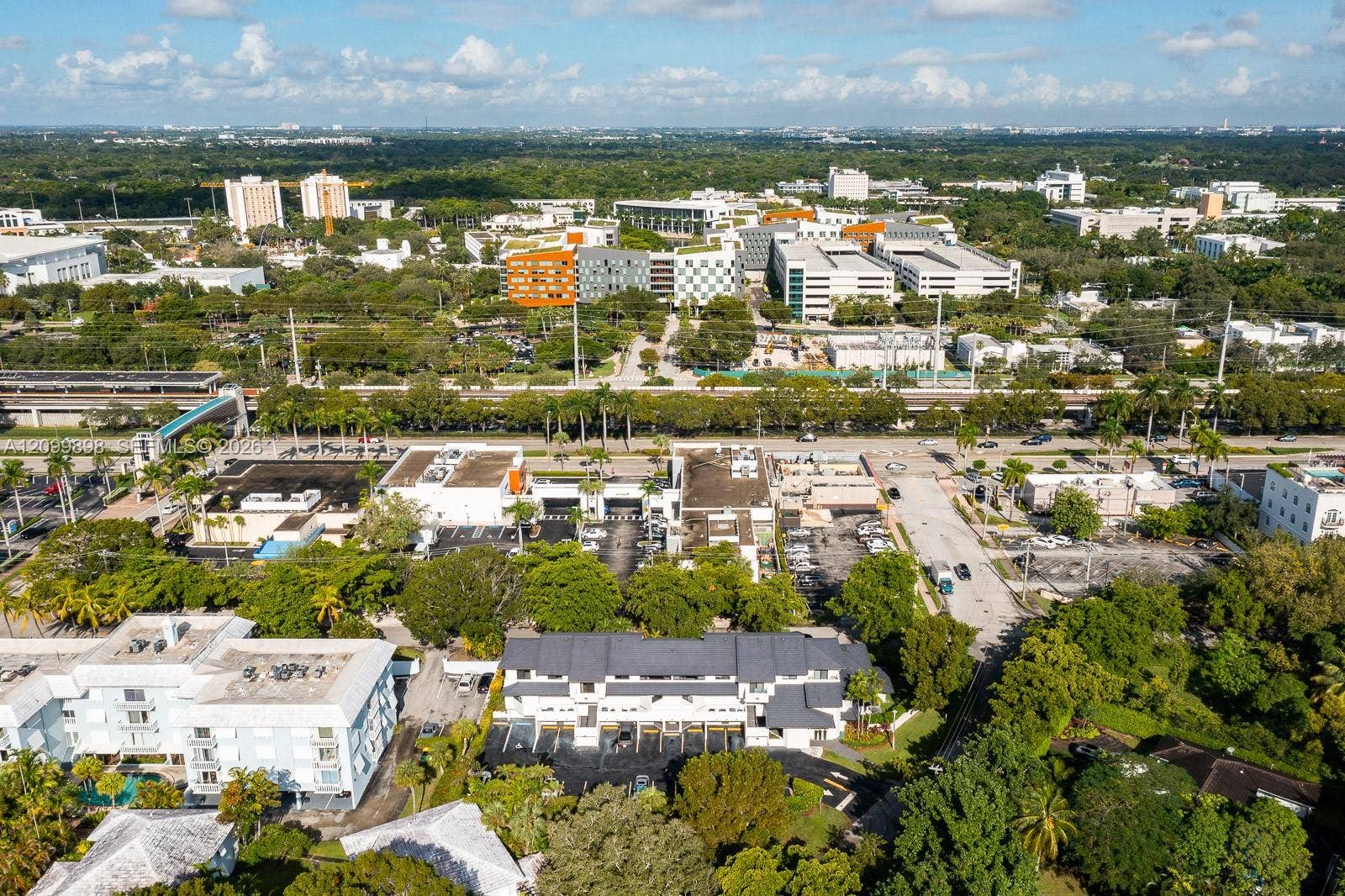 5750 Turin Street, #206, Coral Gables, FL 33146 In this picture, if you look a little to the left and you will see the "Pedestrian Cross Over Bridge" ( SEE THE AQUA BLUE ROOF ) taking everyone safely over the major Highway! At the end of the "Pedestrian Cross Over Bridge is the University Metro-Rail Station and of course beyond that is the whole University of Miami's main campus!