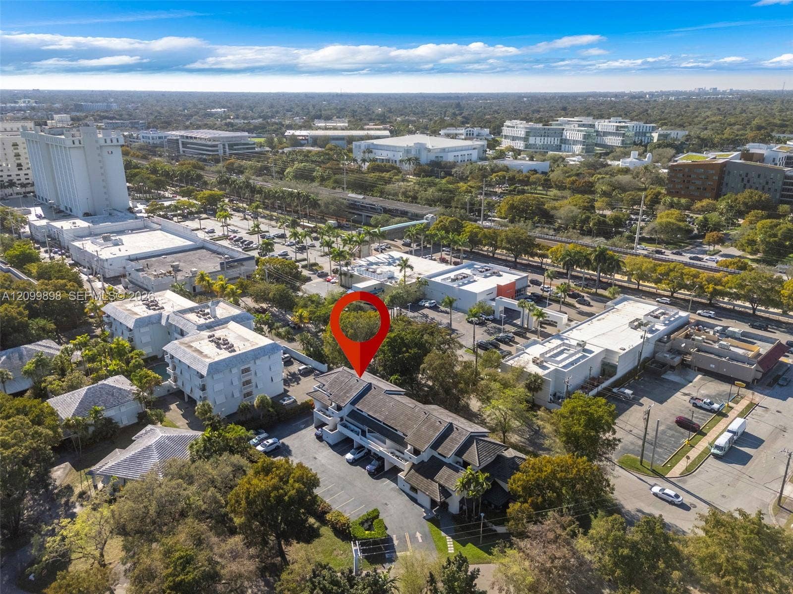 5750 Turin Street, #206, Coral Gables, FL 33146 Looking North-West one can see the University Shopping Center, the "Pedestrian Cross Over Walk-Way...(look for the long blue aqua roof in the middle the picture)" to safely cross the highway and walk to the University Metro-Station and or the University of Miami main campus!!