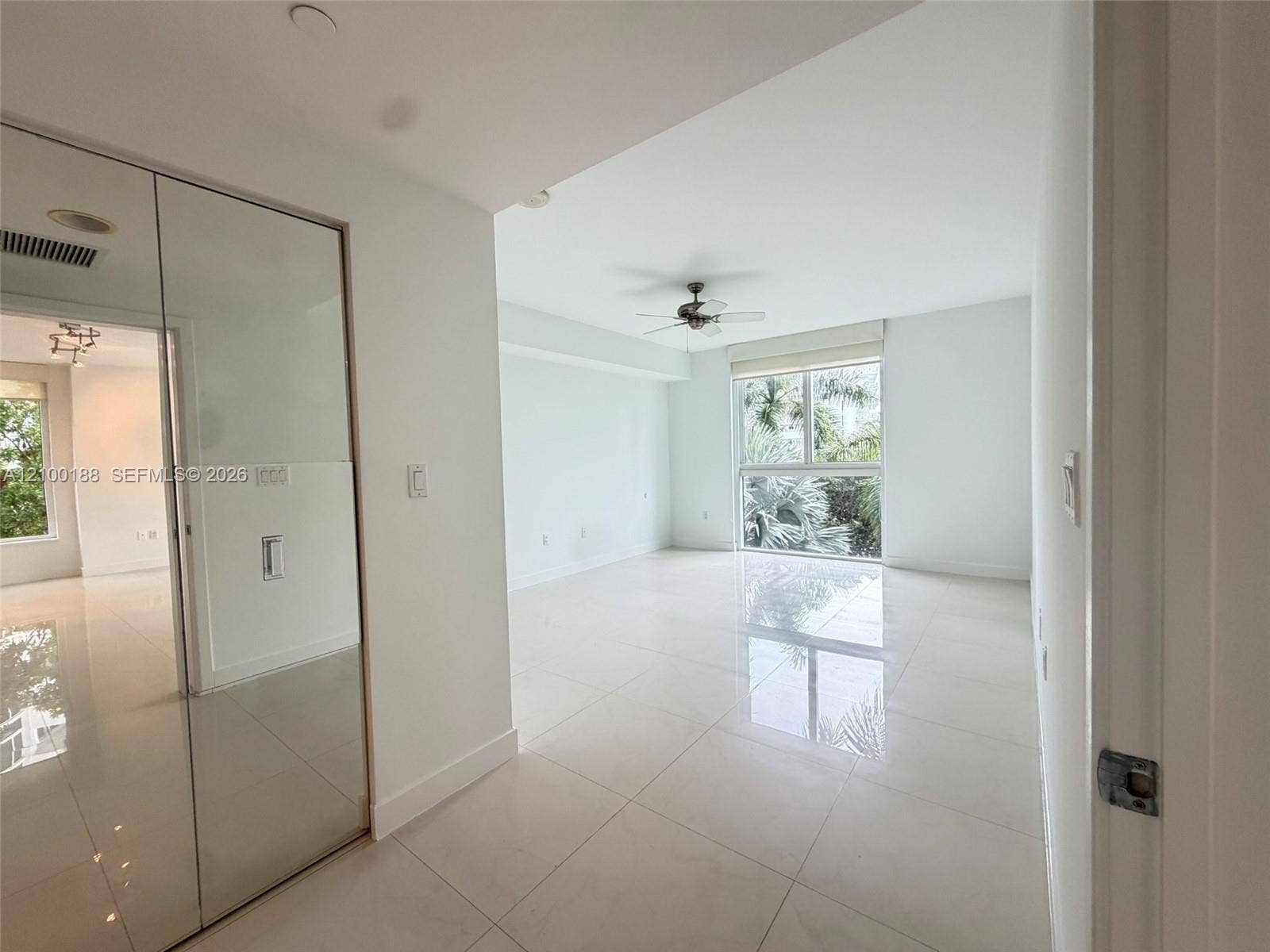 2821 N Ocean Boulevard, #305S, Fort Lauderdale, Fort Lauderdale, FL 33308 Large-format tile flooring, ceiling-mounted paddle fan, and floor-to-ceiling mirrored closet doors