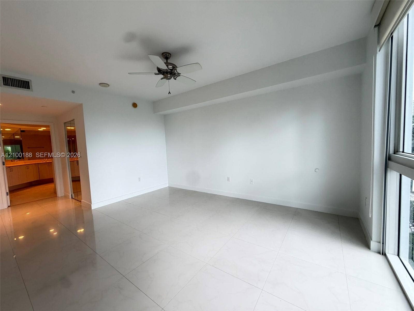 2821 N Ocean Boulevard, #305S, Fort Lauderdale, Fort Lauderdale, FL 33308 Large-format tile flooring, ceiling fan, and floor-to-ceiling windows