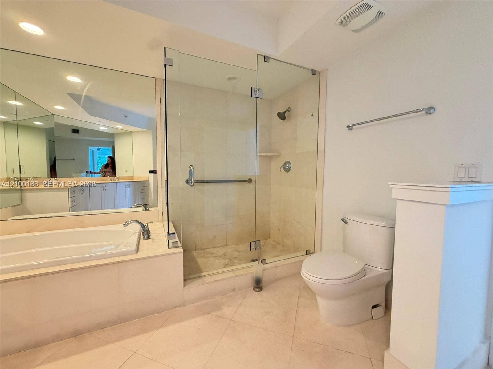 2821 N Ocean Boulevard, #305S, Fort Lauderdale, Fort Lauderdale, FL 33308 Bathroom featuring a soaking tub with a deck-mounted faucet, a frameless glass-enclosed shower, expansive wall-mounted mirror, and tile flooring