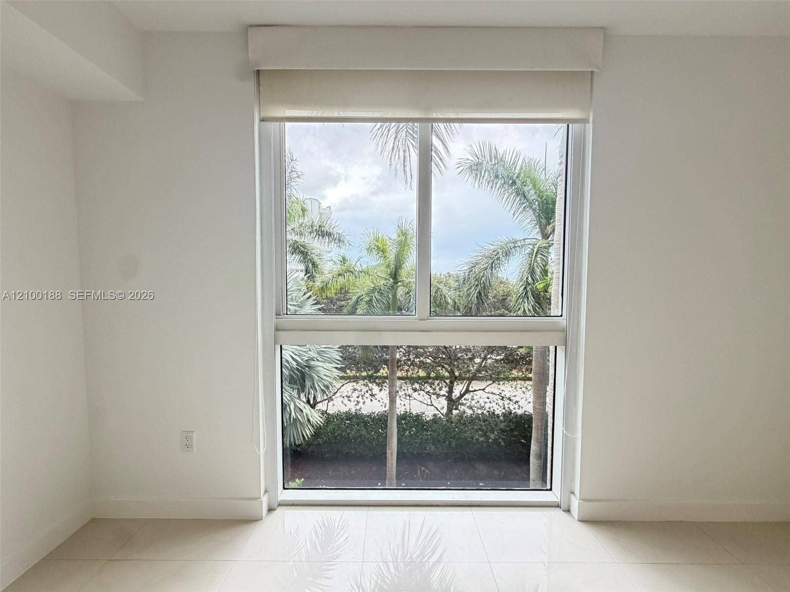 2821 N Ocean Boulevard, #305S, Fort Lauderdale, Fort Lauderdale, FL 33308 Large rectangular window featuring dual-pane glass, a valance, and a retractable roller shade, complemented by tile flooring and neutral wall finishes