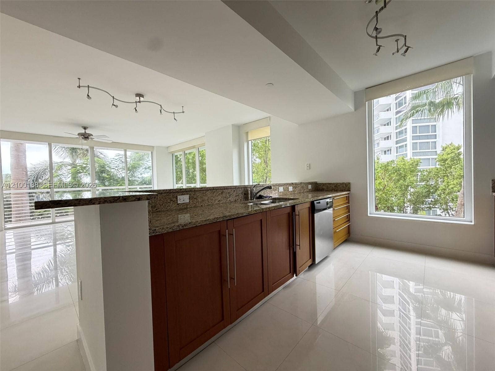 2821 N Ocean Boulevard, #305S, Fort Lauderdale, Fort Lauderdale, FL 33308 Kitchen featuring stone countertops, wood cabinetry, stainless steel dishwasher, polished tile flooring, and floor-to-ceiling windows