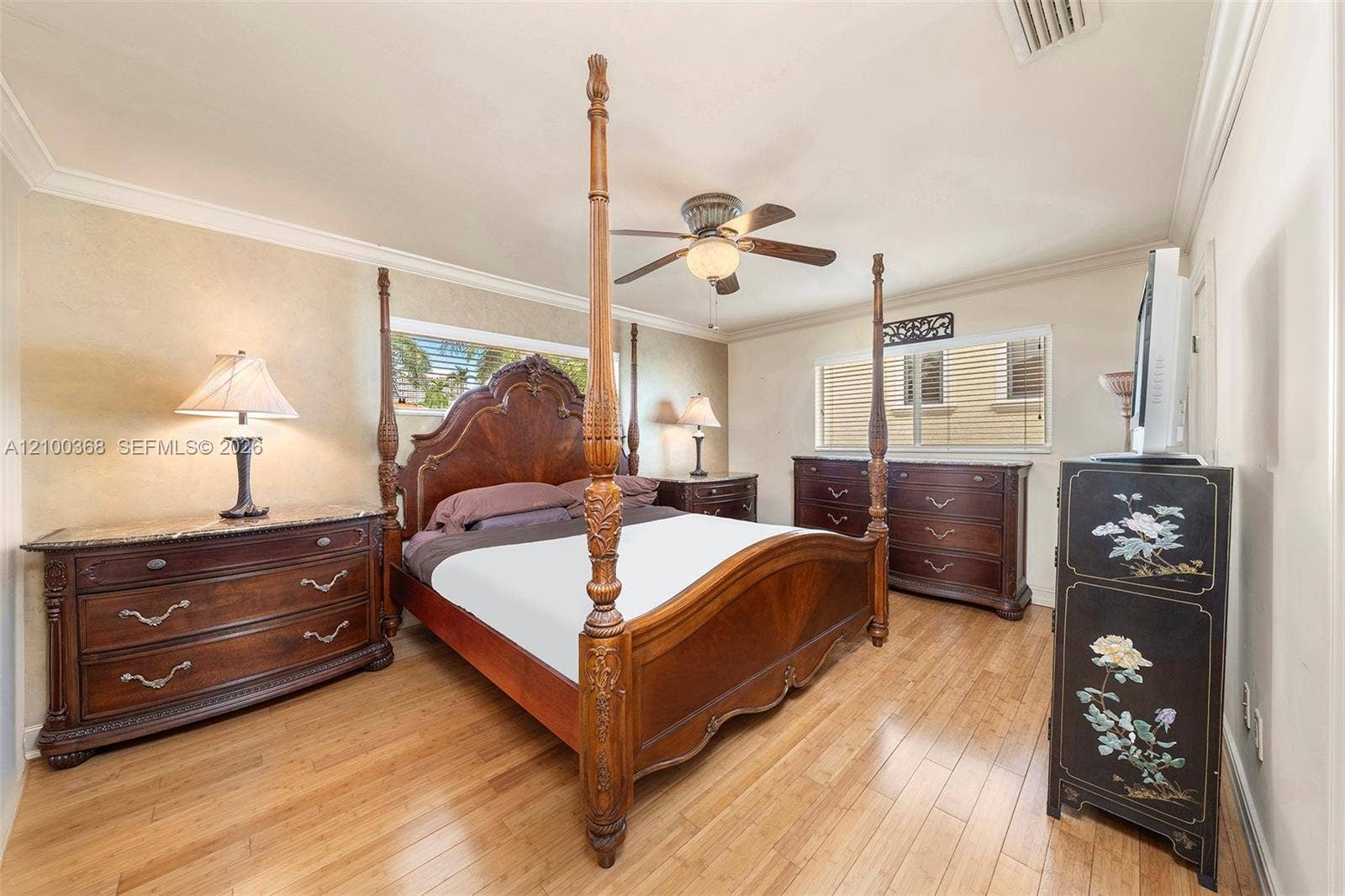 Wood-finish flooring, crown molding, and ceiling fan with integrated lighting