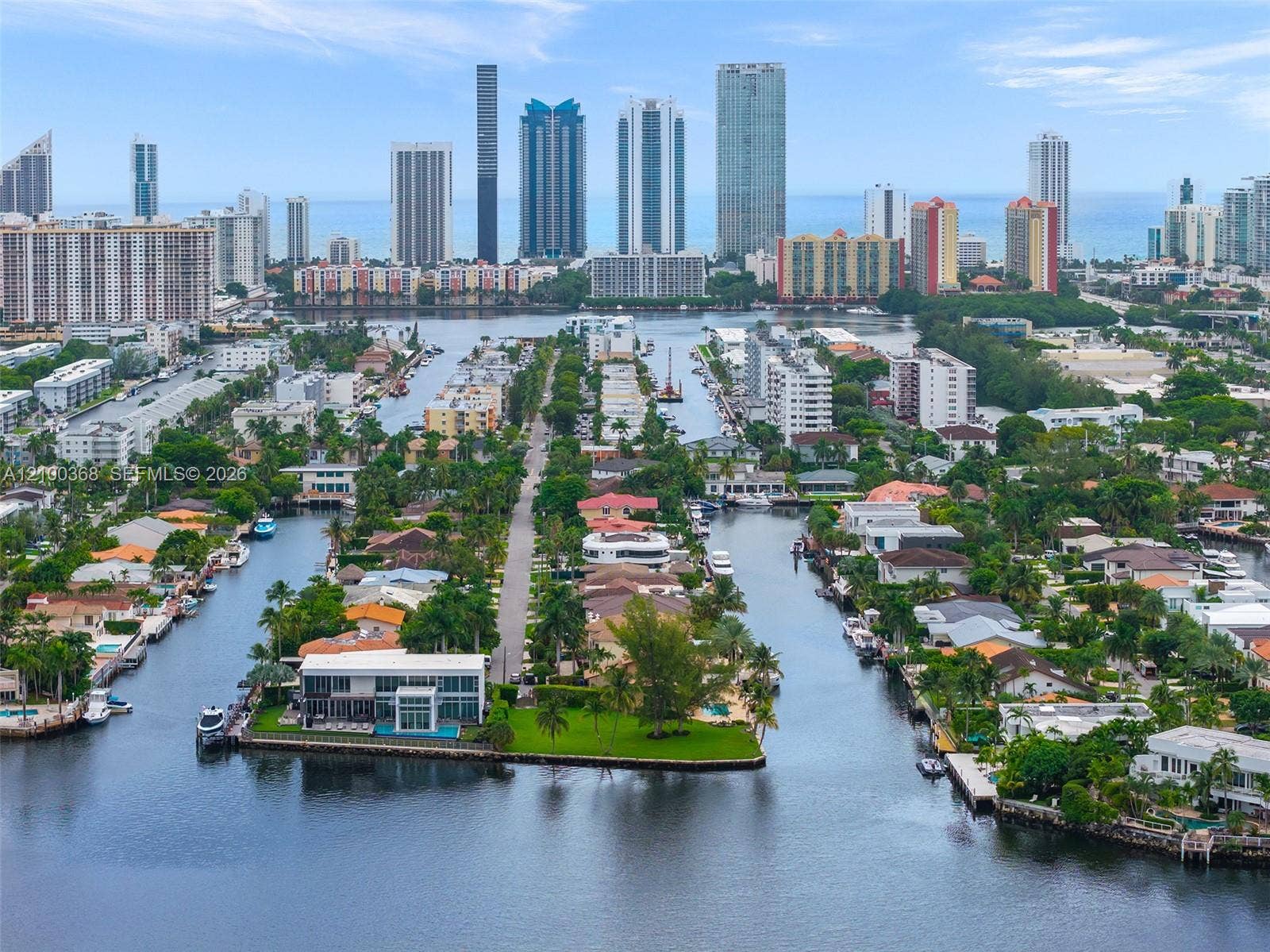 Waterfront property situated on a corner lot featuring a private dock, expansive lawn, and multi-story architectural design