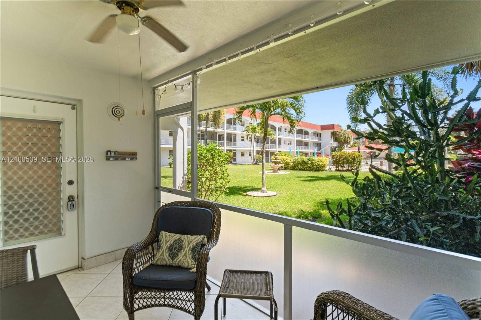 Screened patio offers a view of the manicured grounds and pool