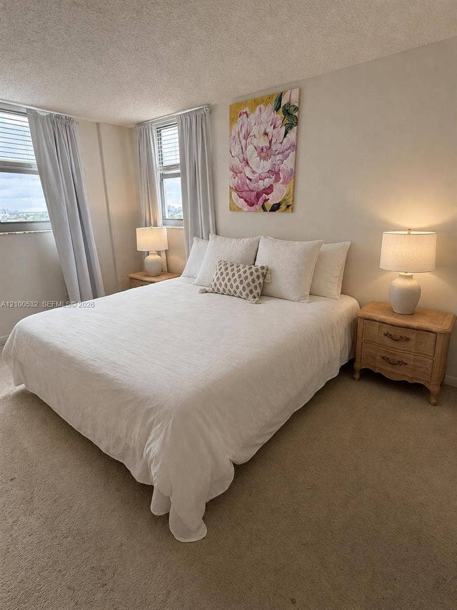 9273 Collins Avenue, #912, Surfside, Surfside, FL 33154 Neutral-toned room featuring wall-to-wall carpeting and multiple windows with integrated blinds