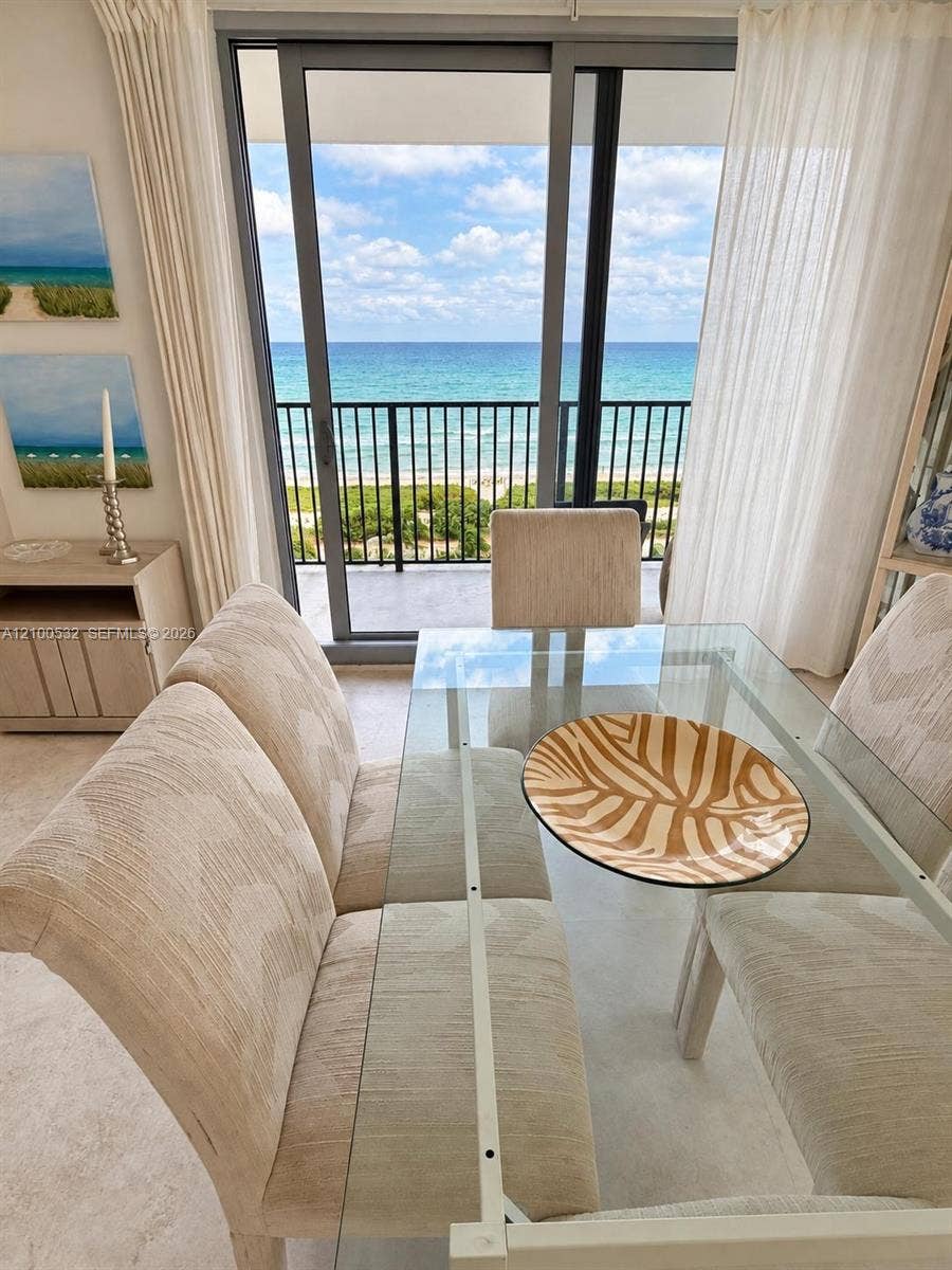 9273 Collins Avenue, #912, Surfside, Surfside, FL 33154 Floor-to-ceiling sliding glass door, metal balcony railing, and ocean backdrop