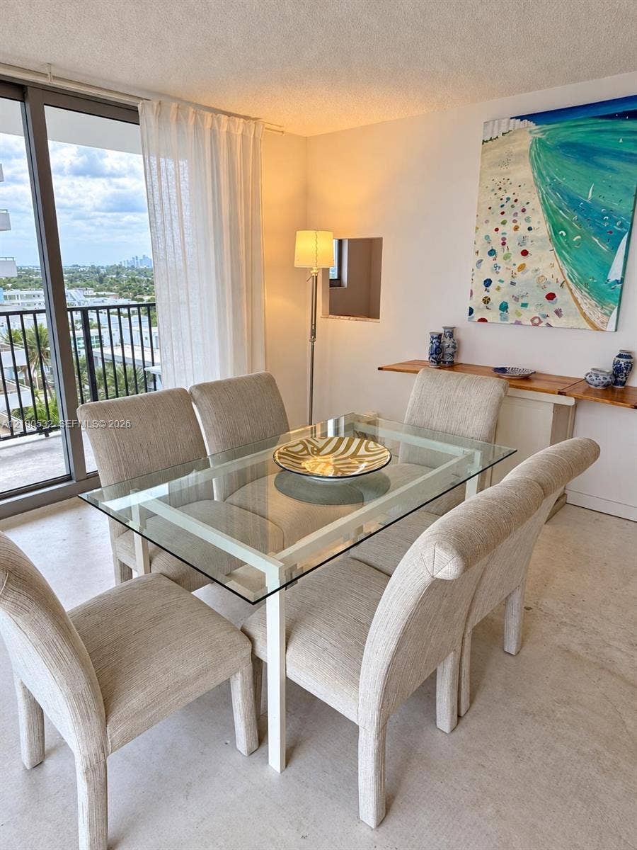 9273 Collins Avenue, #912, Surfside, Surfside, FL 33154 Full-height glass sliding doors, private exterior balcony with metal railing, and recessed wall niche