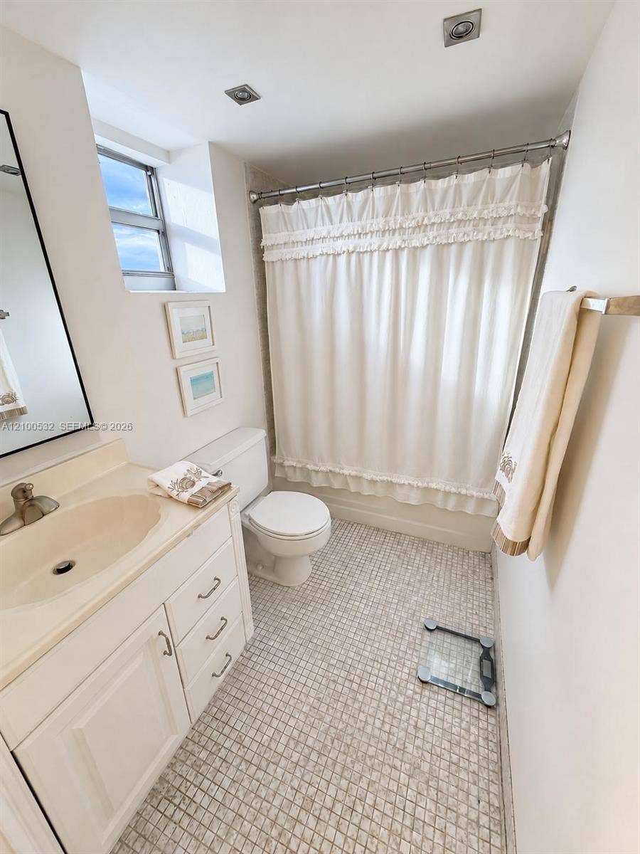 9273 Collins Avenue, #912, Surfside, Surfside, FL 33154 Bathroom featuring a white vanity cabinet, integrated sink with a metal faucet, mosaic tile flooring, and a tub-shower combination with recessed ceiling lighting