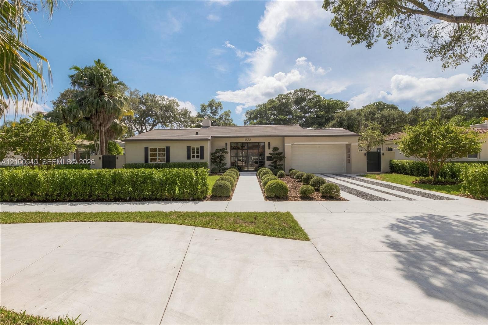 1042 NE 95th Street, Miami Shores, FL 33138 Front of house with circular drive and driveway.