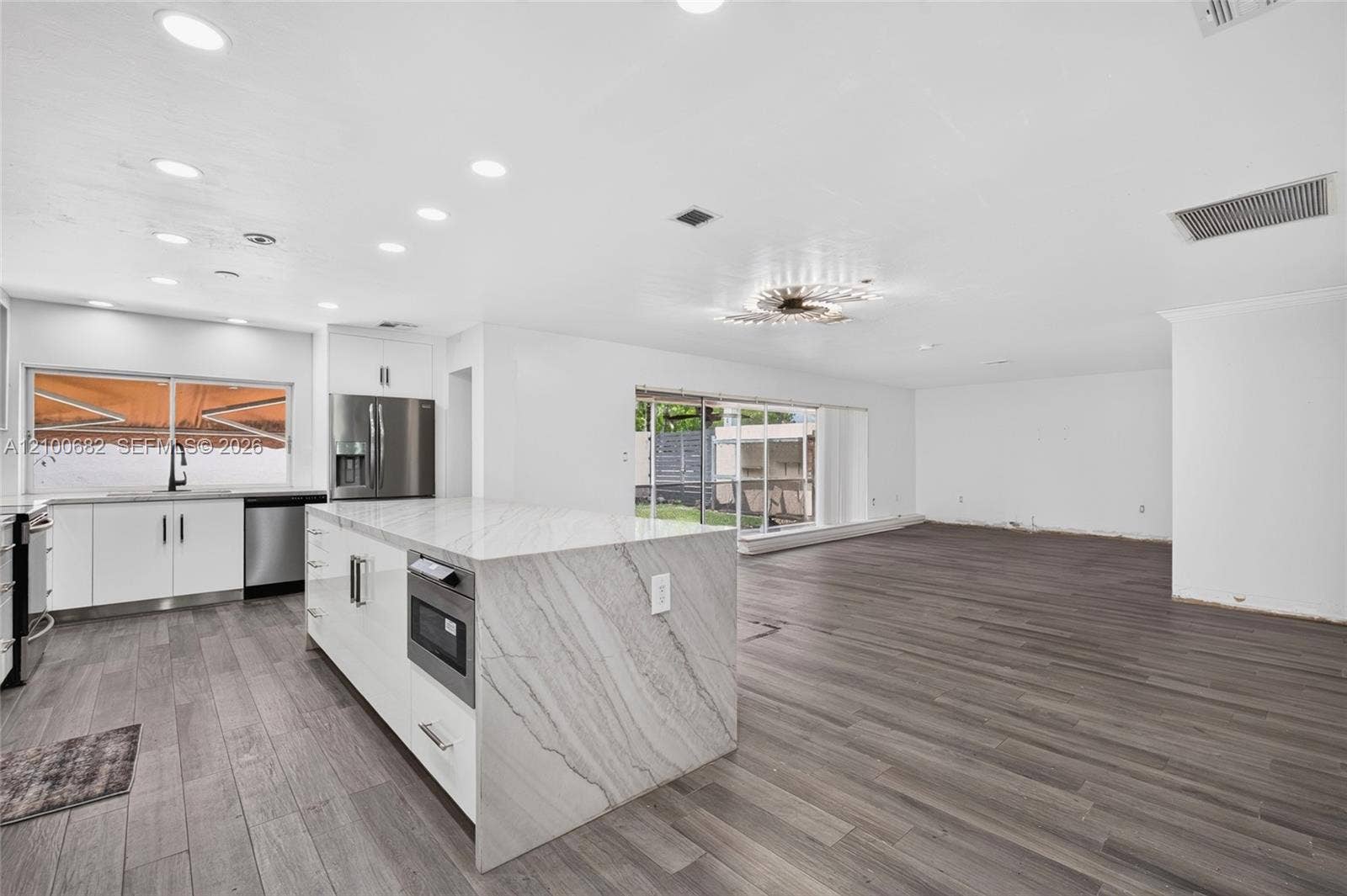 8402 SW 102nd Court, Miami, FL 33173 Open-concept interior featuring vinyl wood-plank flooring *