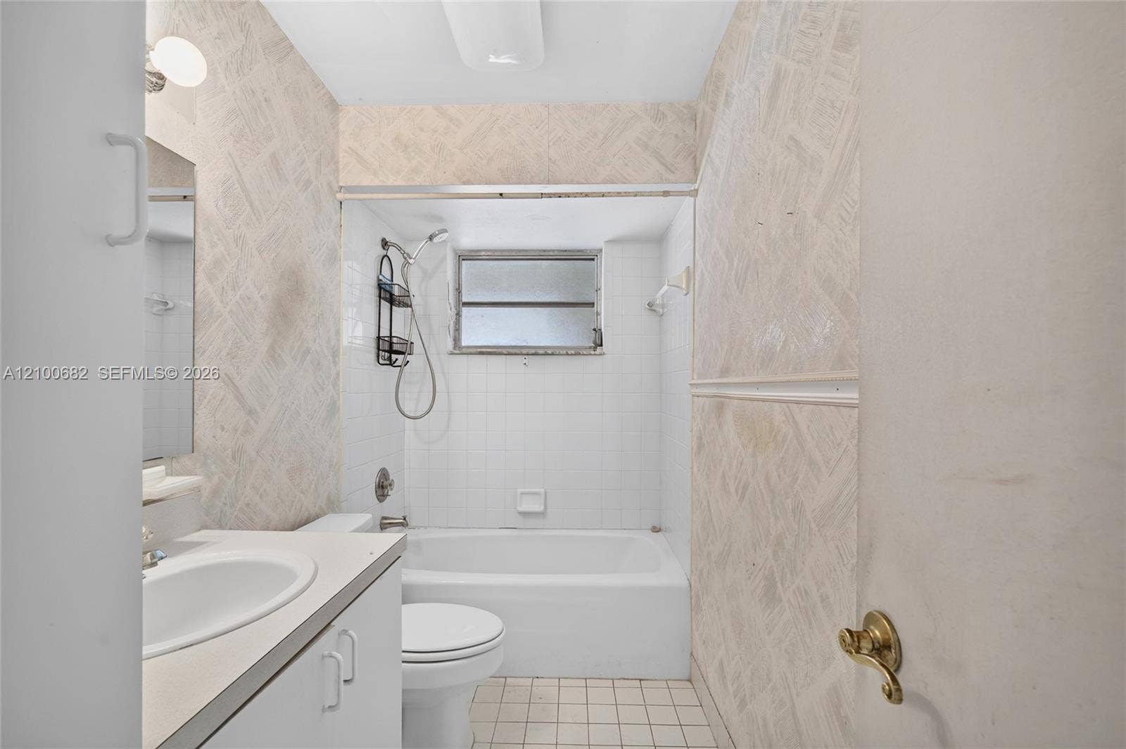 8402 SW 102nd Court, Miami, FL 33173 Hall bathroom featuring a vanity with a white countertop and oval sink, a combined tub and shower enclosure *