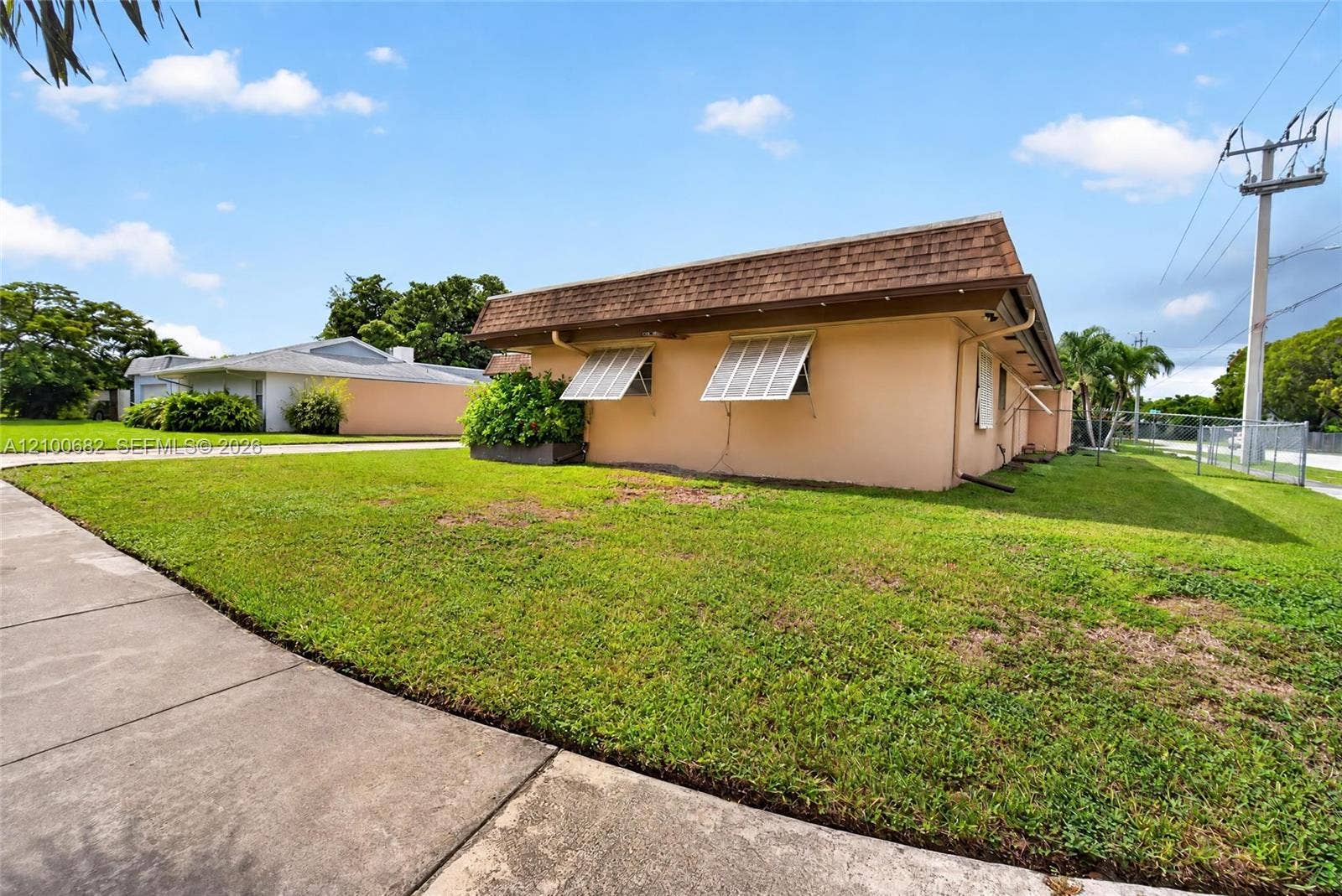 8402 SW 102nd Court, Miami, FL 33173 Single-story residence with a 2012 shingled mansard roofline, and situated on a level corner lot with concrete sidewalk access