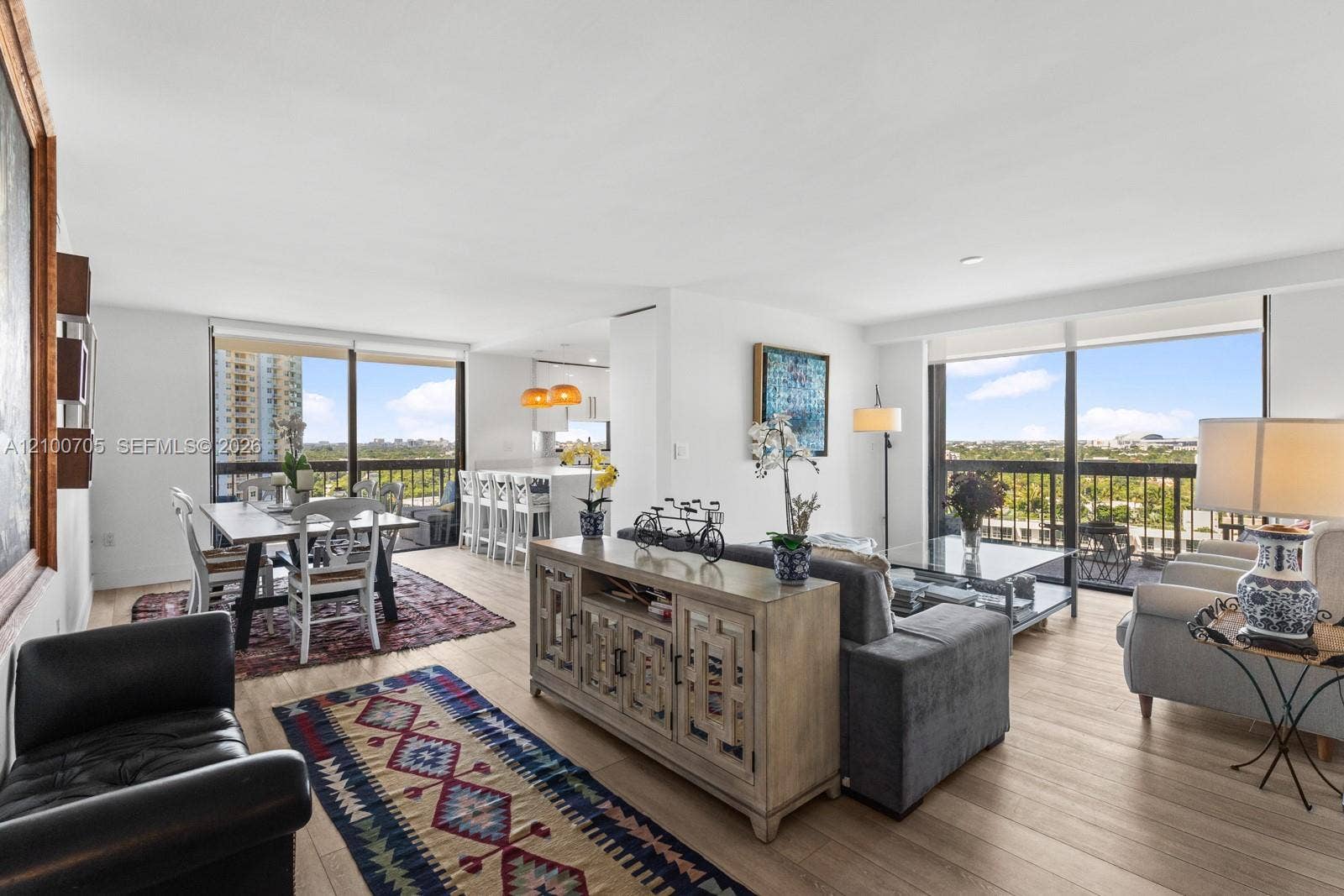 Open-concept living space featuring wood-finish flooring, floor-to-ceiling windows, and recessed lighting