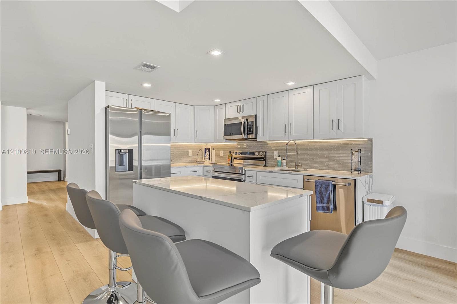 quarts waterfall counters, wood cabinets,