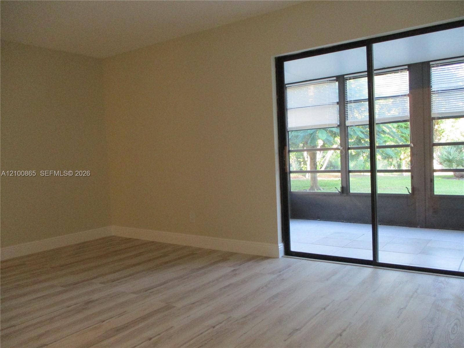 6531 SE Federal Highway, #J112, Stuart, FL 34997 Entrance from sliding door into the master bedroom. Interior space featuring wood-finish flooring, neutral wall paint