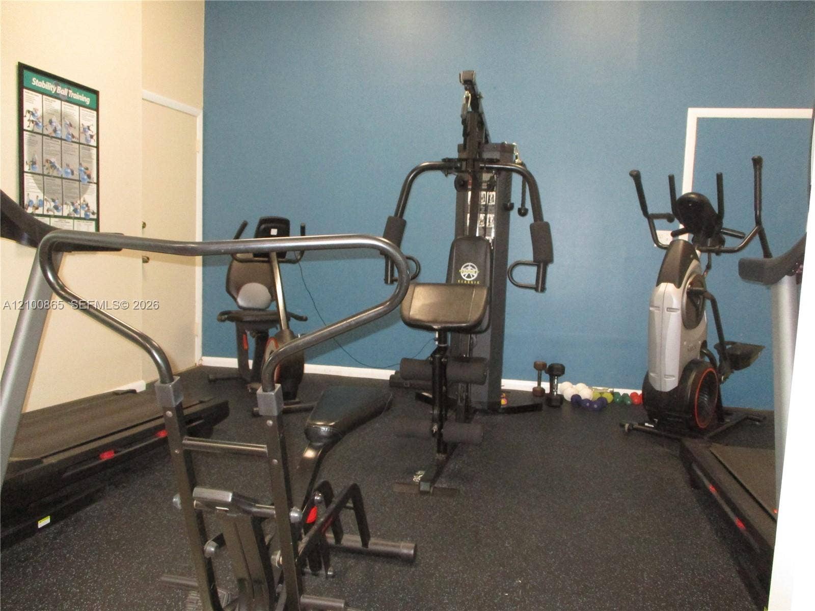 6531 SE Federal Highway, #J112, Stuart, FL 34997 Fitness area featuring impact-resistant rubber flooring and an accent wall