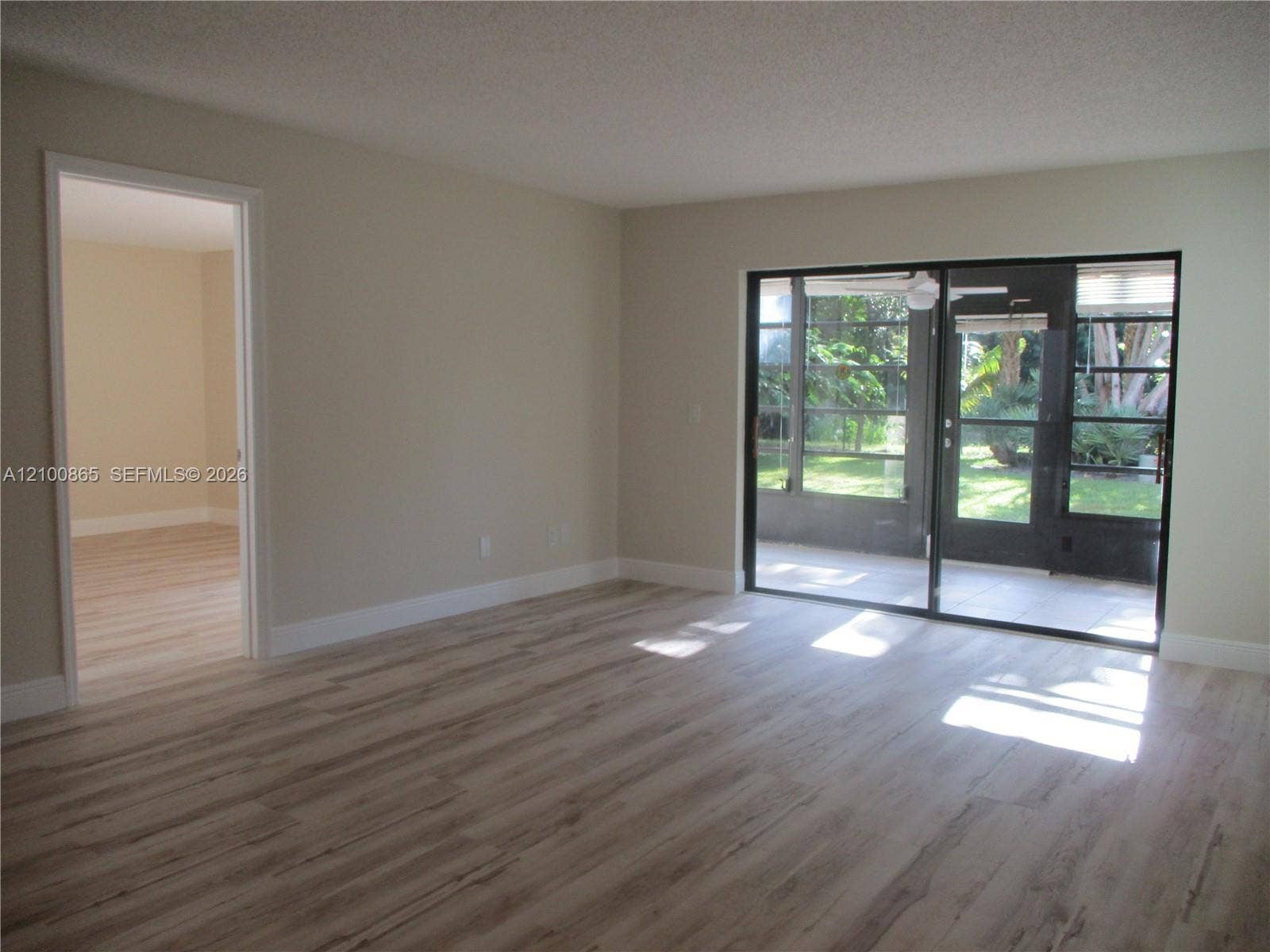 6531 SE Federal Highway, #J112, Stuart, FL 34997 sliding glass doors to outdoor area, neutral wall tones, and white trim