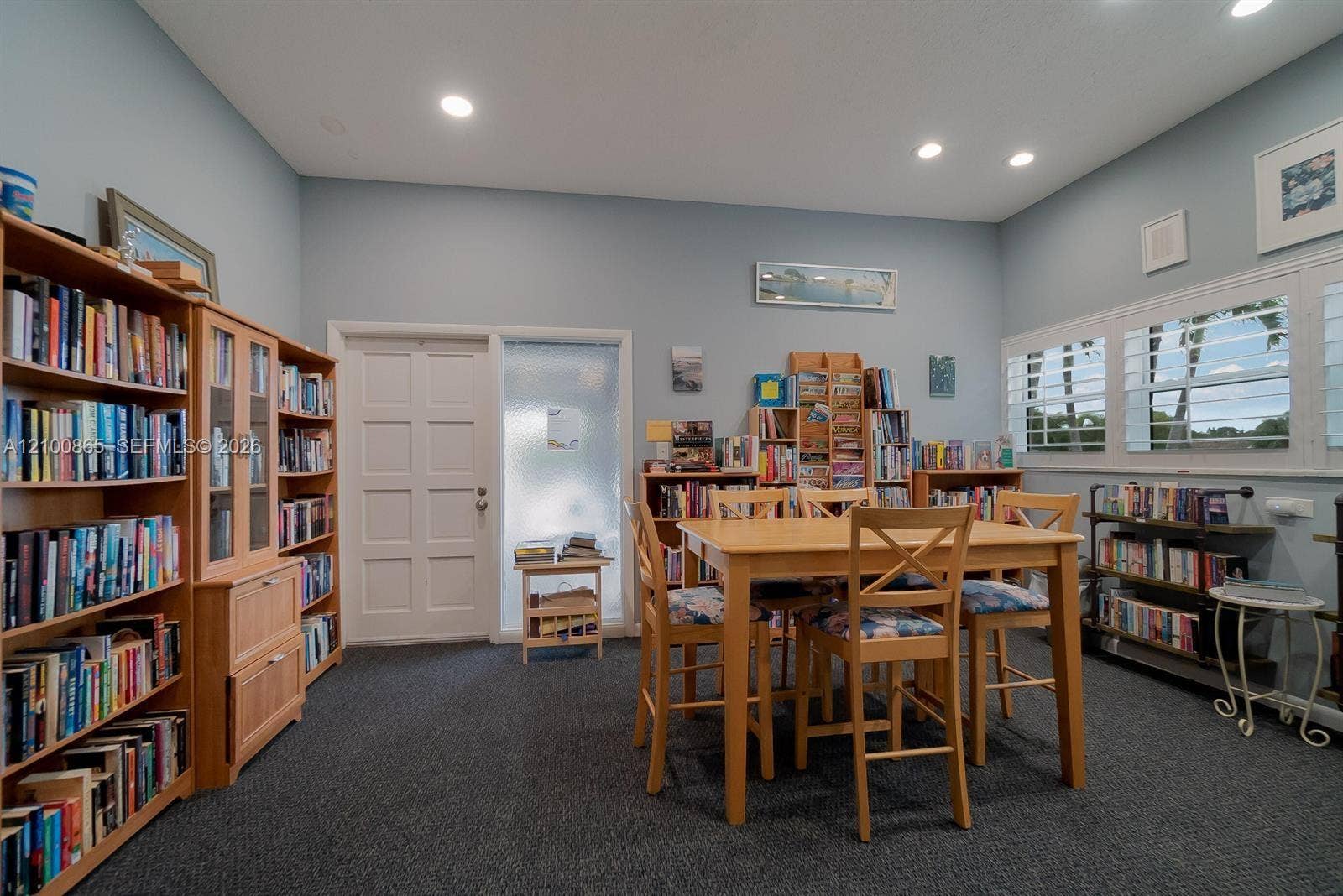6531 SE Federal Highway, #J112, Stuart, FL 34997 Built-in wood cabinetry, recessed lighting, carpeted flooring, white interior paneled door, and multi-pane windows with integrated shutters