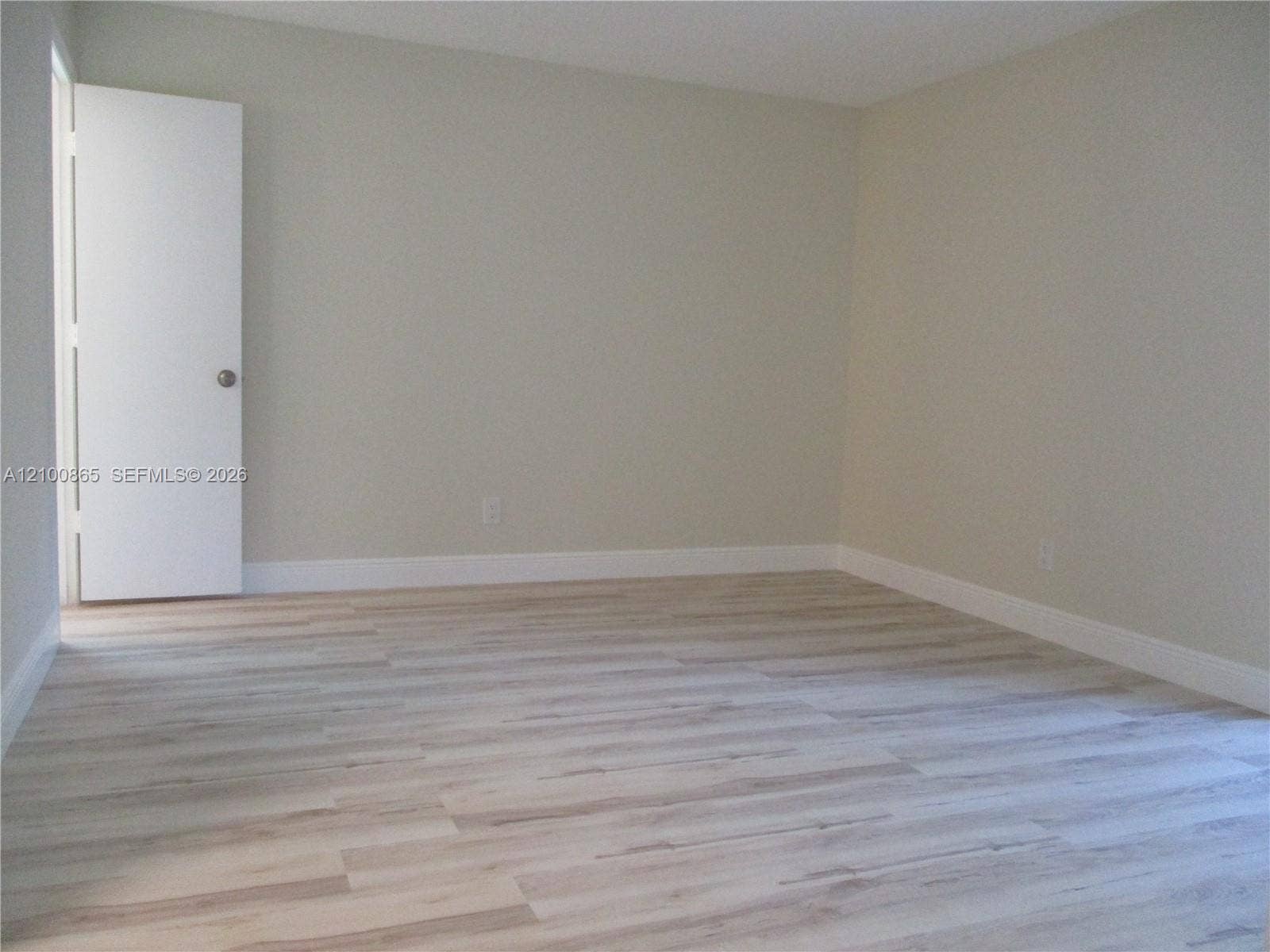 6531 SE Federal Highway, #J112, Stuart, FL 34997 Master bedroom Interior room featuring neutral-toned walls and wood-finish flooring