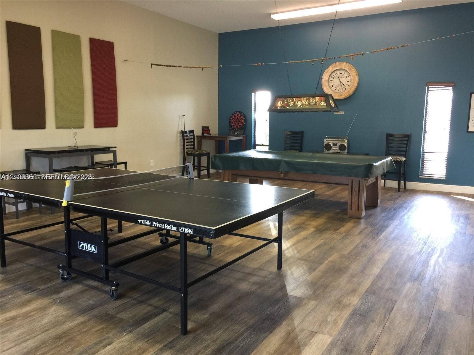 6531 SE Federal Highway, #J112, Stuart, FL 34997 Spacious room featuring wood-finish flooring, high ceilings, recessed lighting, and vertical window treatments