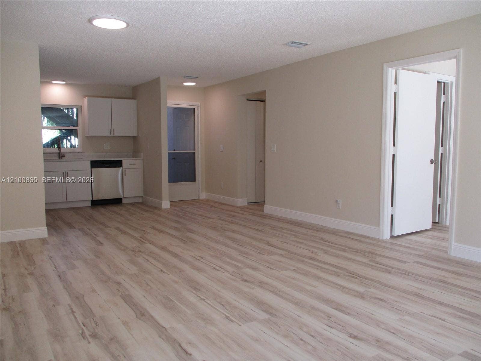 6531 SE Federal Highway, #J112, Stuart, FL 34997 Maple LVP throughout, recessed lighting, white cabinetry, stainless steel dishwasher, and a lightwhite-colored countertop