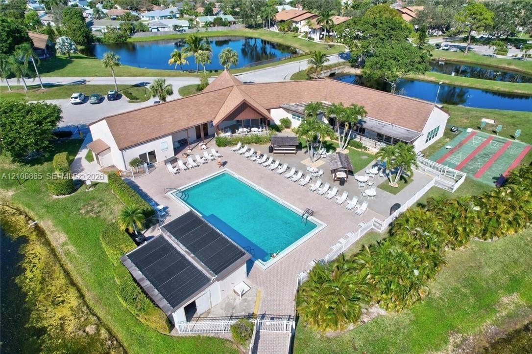 6531 SE Federal Highway, #J112, Stuart, FL 34997 Community amenity center featuring a swimming pool, paved pool deck, recreation room, sauna, shuffleboard court, and perimeter landscaping, situated near multiple water features