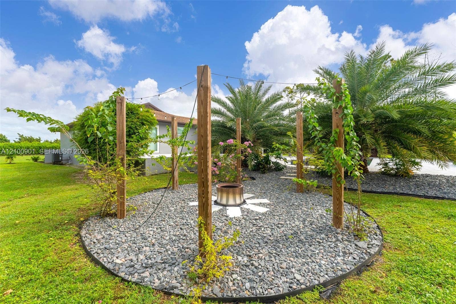 Outdoor firepit SET UP FOR SWINGS....BOUGANVILLA IS THE PLANT WILL EVENTUALLY BE COVERED IN FLOWERS