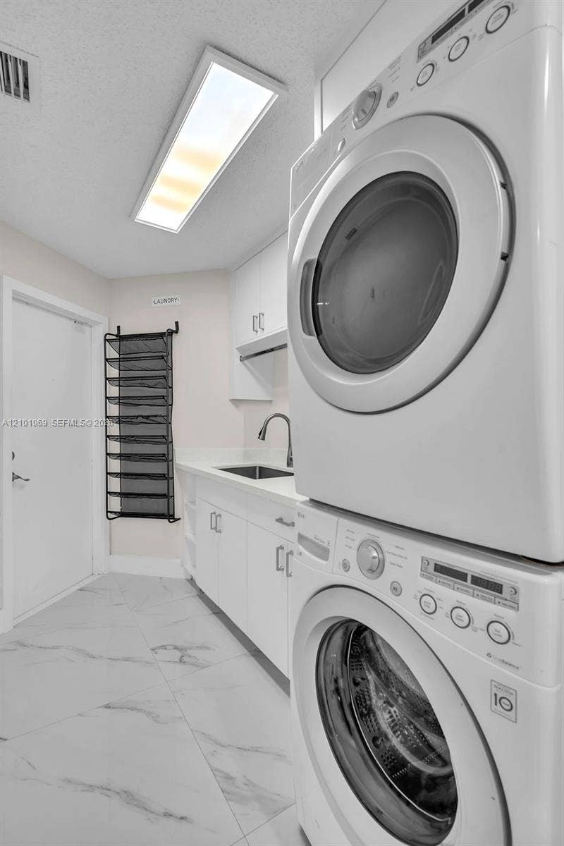 Laundry room with granite counter tops and sink