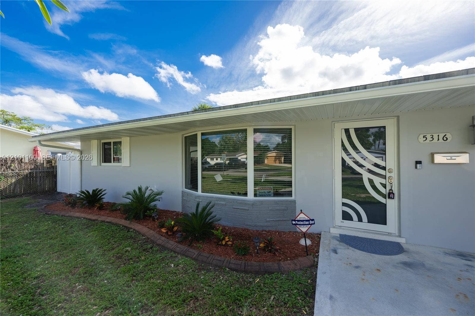 5316 Buchanan Street, #0, Hollywood, Hollywood, FL 33021 Well-manicured front of the house featuring brand Impact Windows.