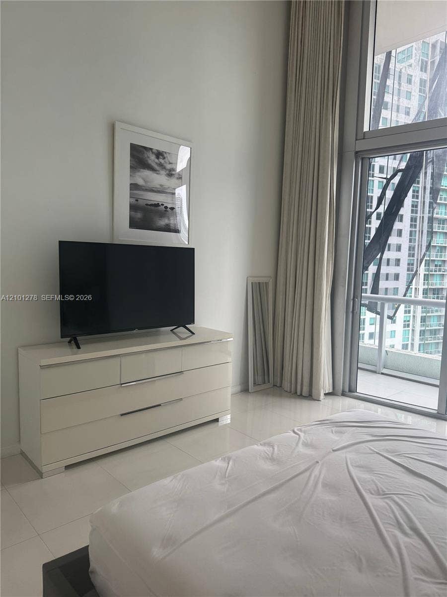 485 Brickell Avenue, #2806, Miami, Miami, FL 33131 Floor-to-ceiling windows, white tile flooring, and a private balcony access point